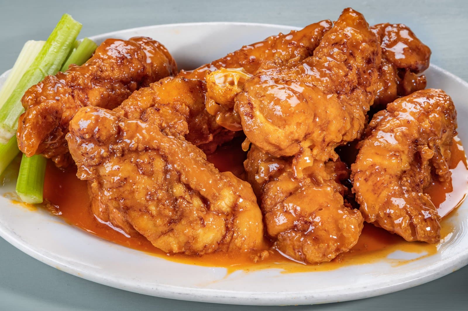 Buffalo tenders glazed in sauce with celery