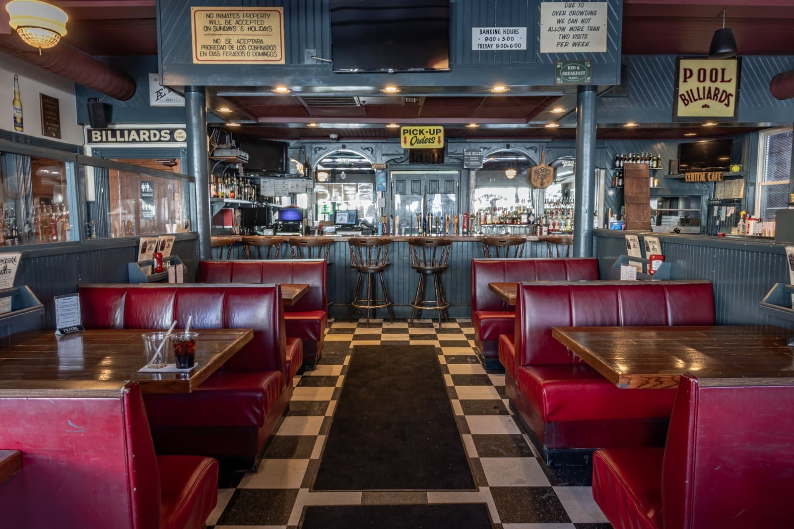 The dining room with red booths and vintage signs