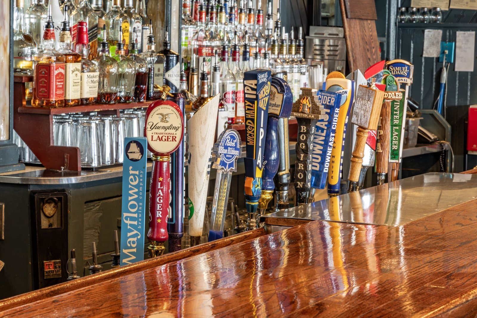 Draft beer tap handles lined up along the bar