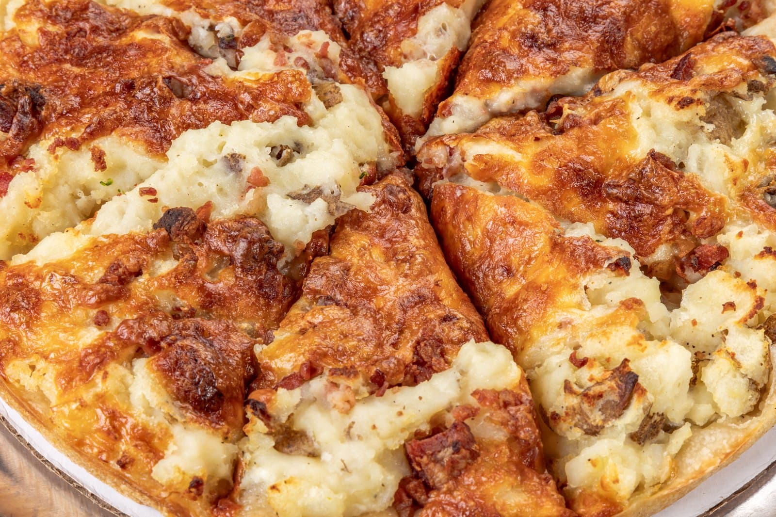 Loaded potato and bacon pizza close-up