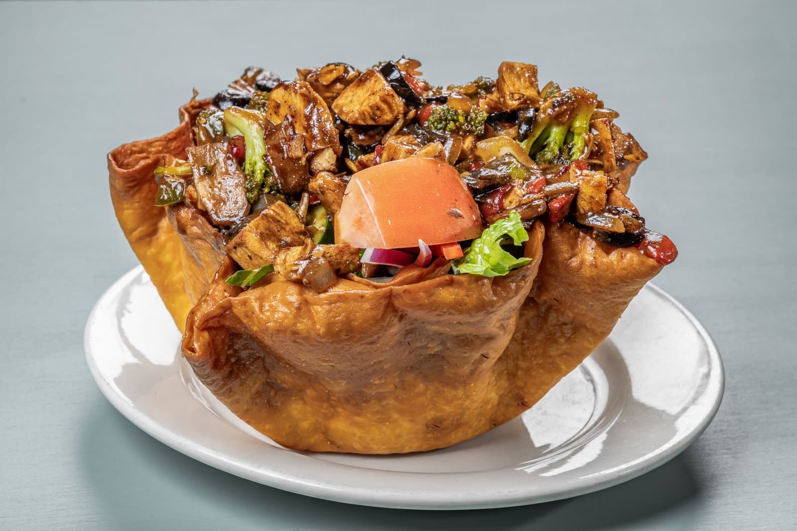 Grilled chicken taco salad in a crispy tortilla bowl